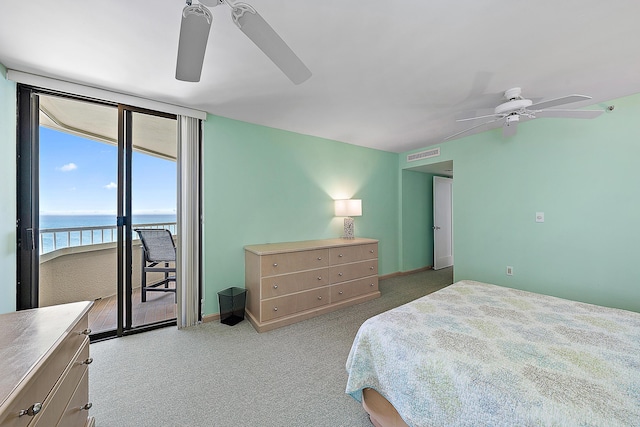 carpeted bedroom featuring ceiling fan, a wall of windows, access to outside, and a water view