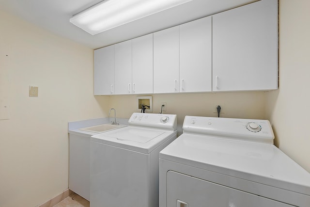 washroom with washer and clothes dryer, sink, and cabinets