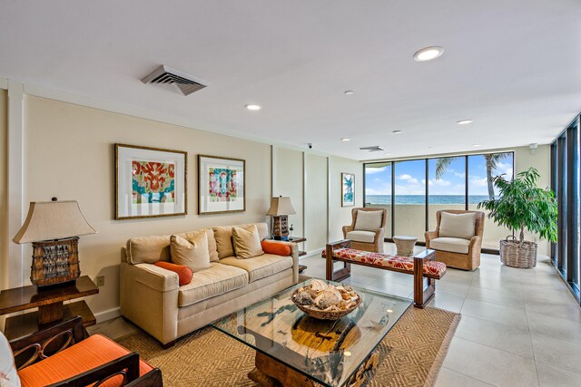 living room featuring a water view and expansive windows