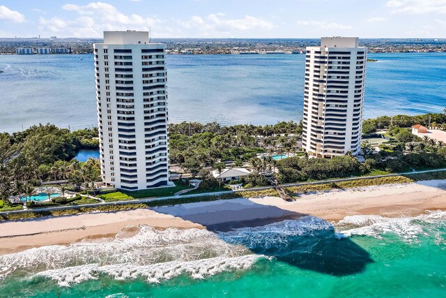 bird's eye view featuring a water view and a beach view