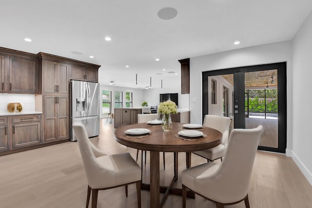 dining space with light hardwood / wood-style floors and a wealth of natural light