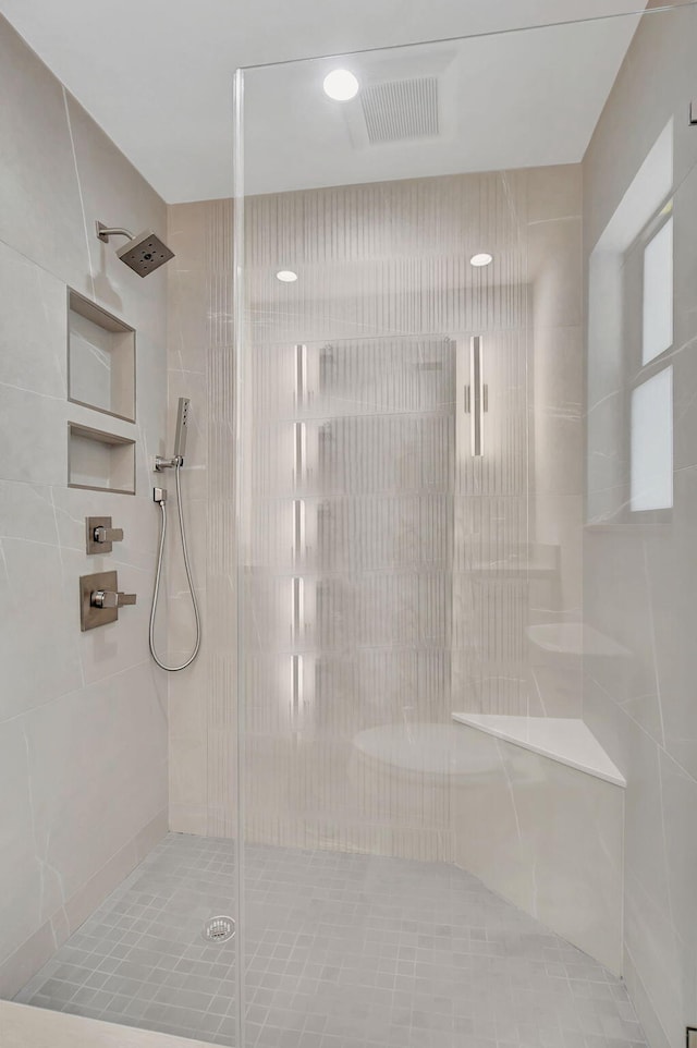 bathroom featuring a shower with door