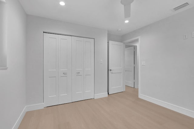 unfurnished bedroom featuring light hardwood / wood-style floors and a closet