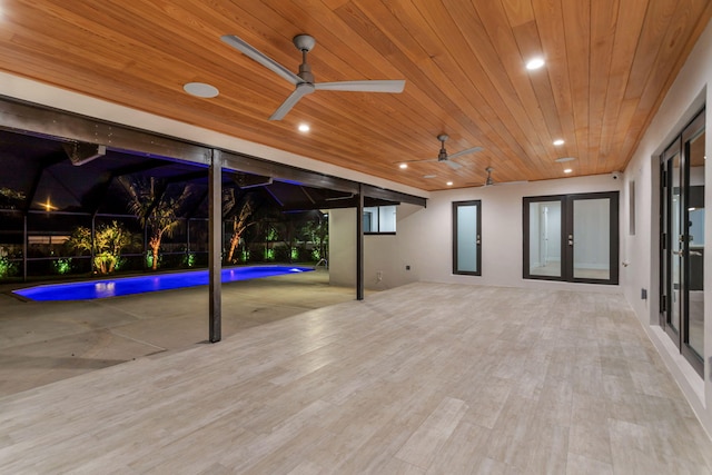 view of patio with french doors, ceiling fan, and a lanai