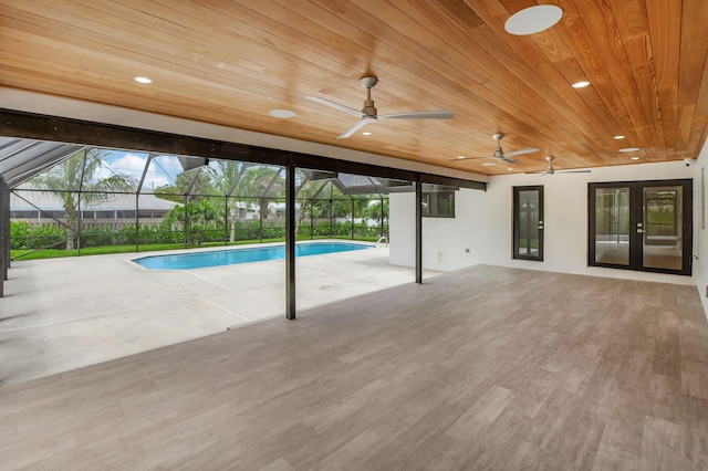 view of pool with french doors, a patio, a lanai, and ceiling fan