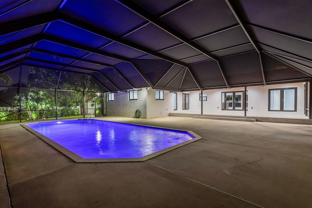 view of swimming pool featuring a lanai and a patio area