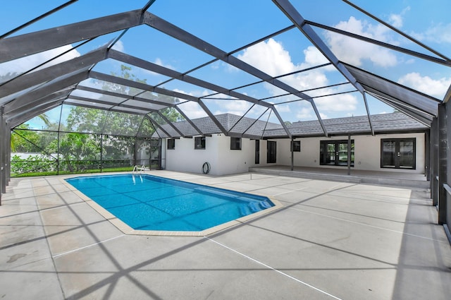 view of swimming pool with a patio and glass enclosure