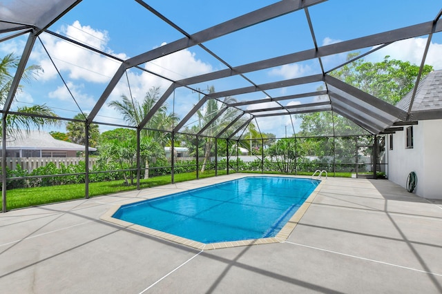 view of pool featuring a patio and glass enclosure