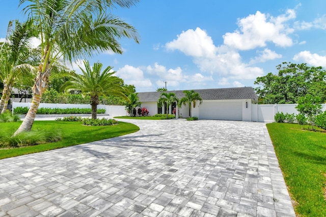 view of front of house featuring a front lawn and a garage