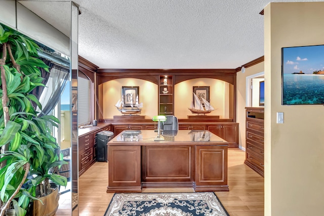 office area with crown molding, a textured ceiling, and light hardwood / wood-style floors