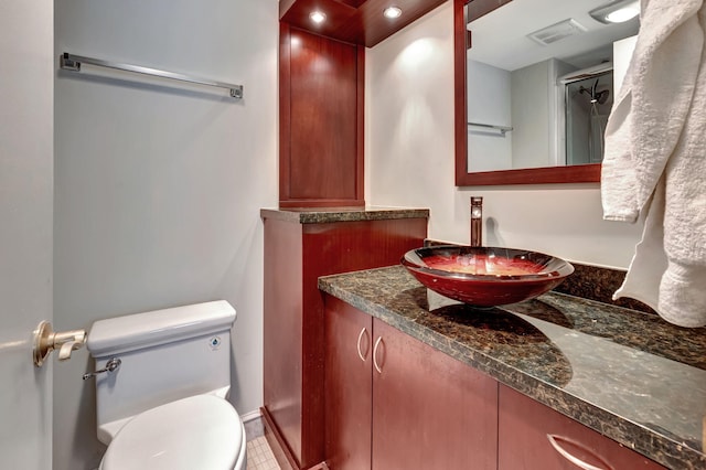 bathroom with tile patterned flooring, toilet, and vanity