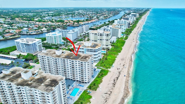 drone / aerial view featuring a water view and a beach view