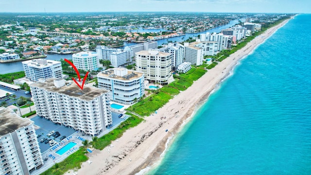 birds eye view of property featuring a water view and a view of the beach