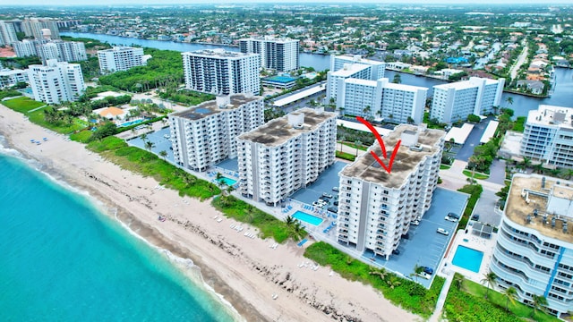 drone / aerial view with a water view and a view of the beach