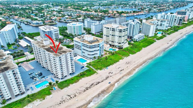 drone / aerial view with a beach view and a water view