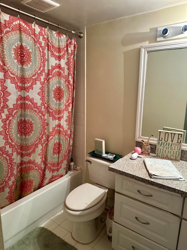 full bathroom with vanity, shower / bath combo with shower curtain, toilet, and tile patterned floors