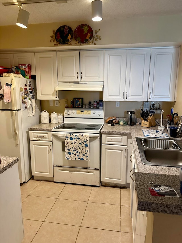 kitchen featuring white cabinetry, sink, white appliances, and light tile patterned floors