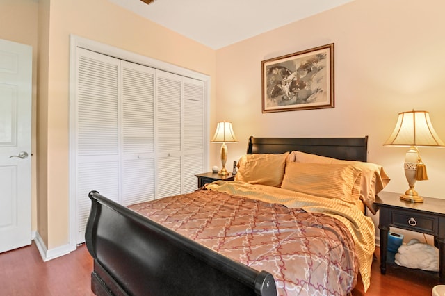 bedroom featuring a closet and dark hardwood / wood-style floors