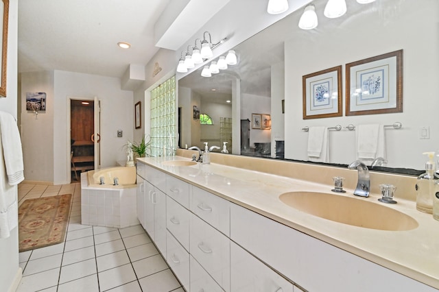 bathroom featuring vanity, tiled tub, and tile patterned flooring