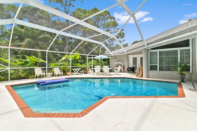 view of pool with a patio and a lanai