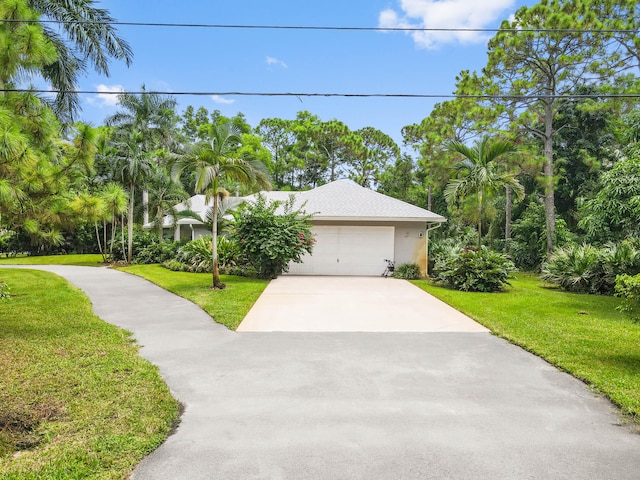 view of front of home featuring a garage and a front lawn