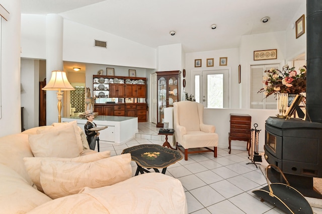 living room with vaulted ceiling and light tile patterned floors