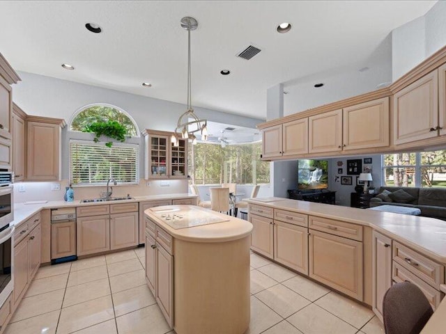 kitchen with light tile patterned floors, a chandelier, sink, light brown cabinets, and pendant lighting