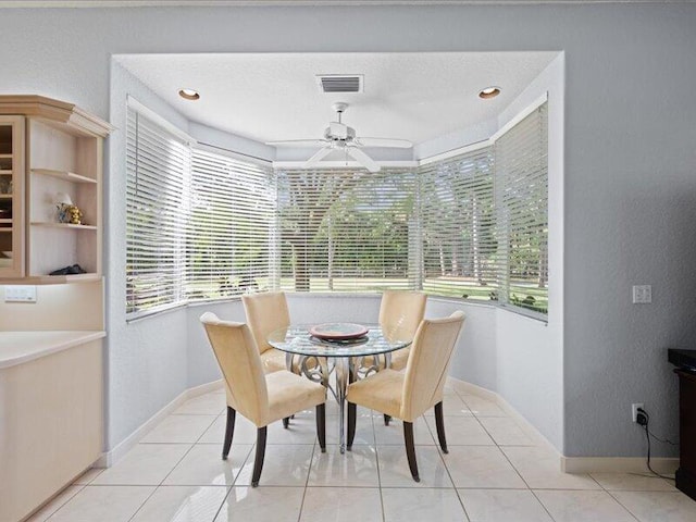 tiled dining room with ceiling fan