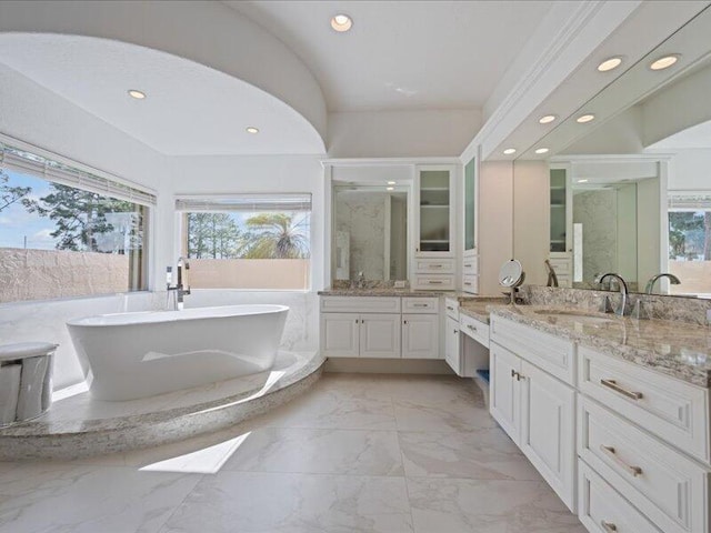 bathroom featuring shower with separate bathtub, plenty of natural light, and vanity