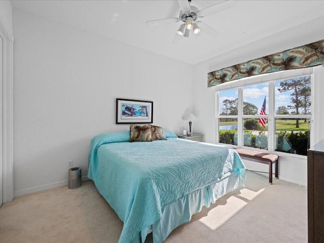 bedroom featuring light colored carpet and ceiling fan