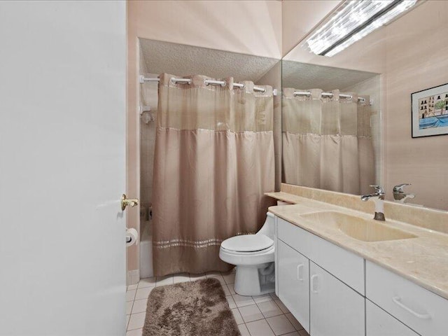 bathroom with tile patterned flooring, toilet, walk in shower, and vanity