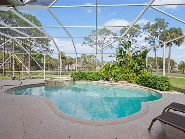 view of pool with a patio, a lanai, and an in ground hot tub