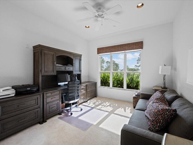 office space featuring ceiling fan and light carpet