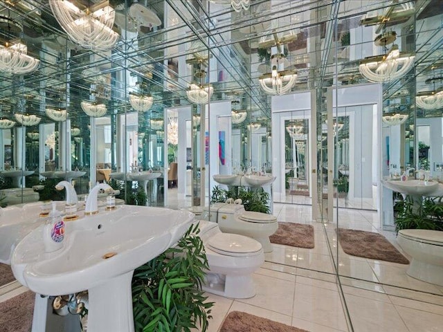 bathroom with tile patterned flooring, toilet, a bidet, and sink