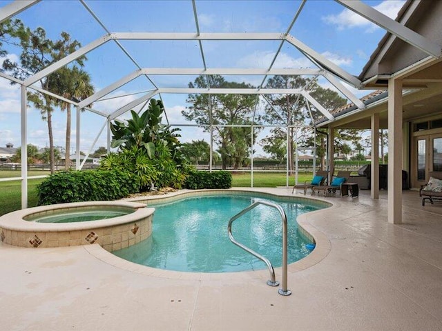 view of swimming pool featuring a lanai, a patio area, and an in ground hot tub