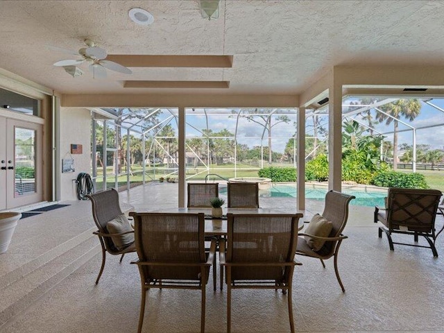 sunroom / solarium featuring a skylight, ceiling fan, and french doors