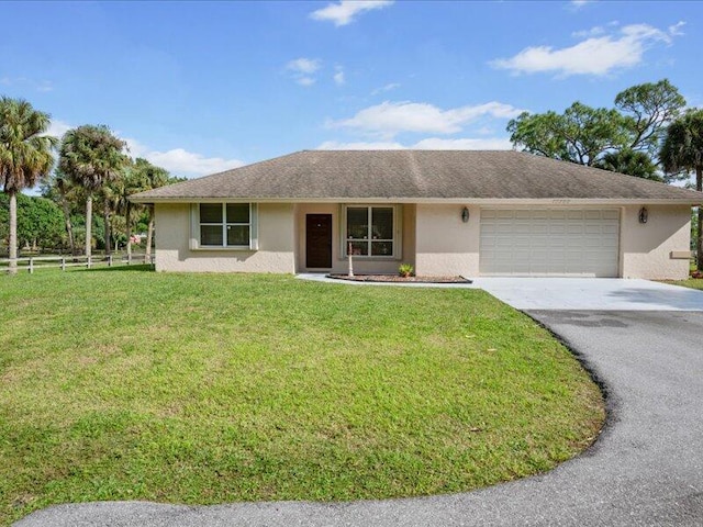 ranch-style house with a garage and a front lawn