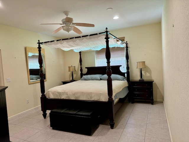 bedroom with multiple windows, ceiling fan, and light tile patterned floors