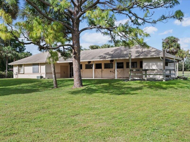 rear view of house with a yard