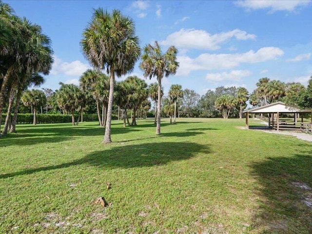 view of property's community with a lawn and a gazebo