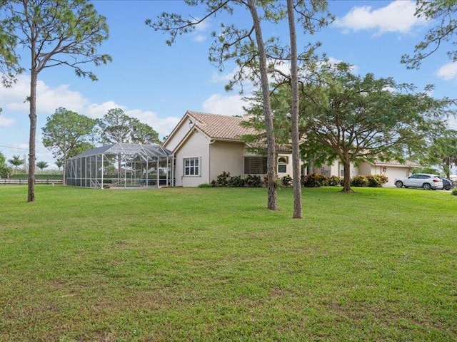 view of yard featuring glass enclosure