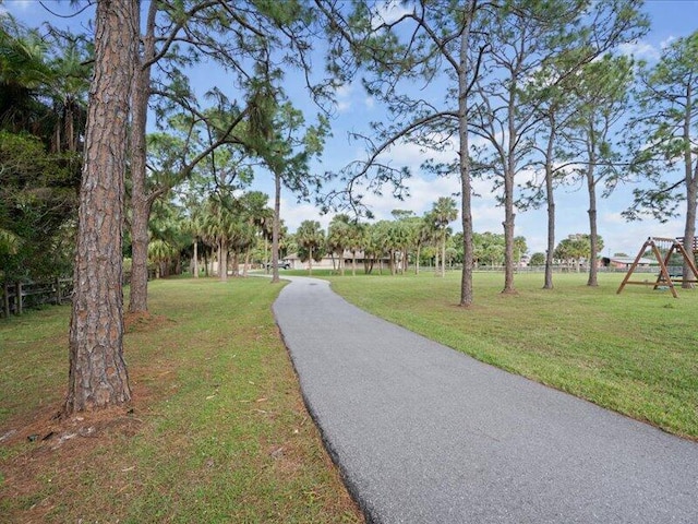 view of community with a yard and a playground