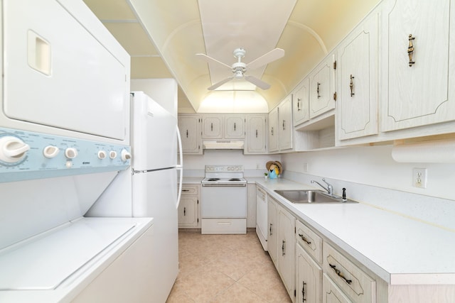 kitchen with white appliances, sink, stacked washing maching and dryer, light tile patterned flooring, and ceiling fan