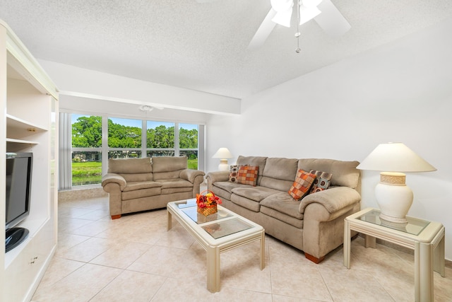 tiled living room featuring a textured ceiling and ceiling fan