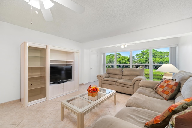 tiled living room featuring a textured ceiling, ceiling fan, and built in shelves