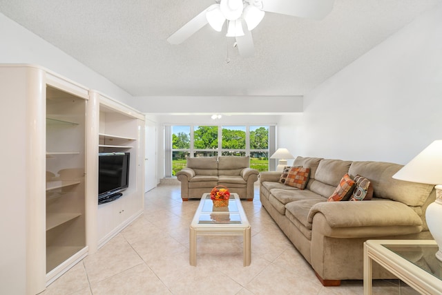 tiled living room featuring ceiling fan and a textured ceiling