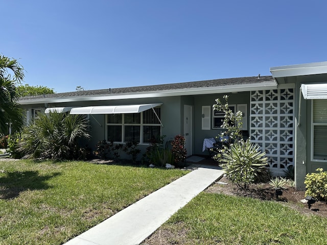 767 E High Point Dr E Unit C, Delray Beach, FL 33445 - property entrance with a lawn and stucco siding