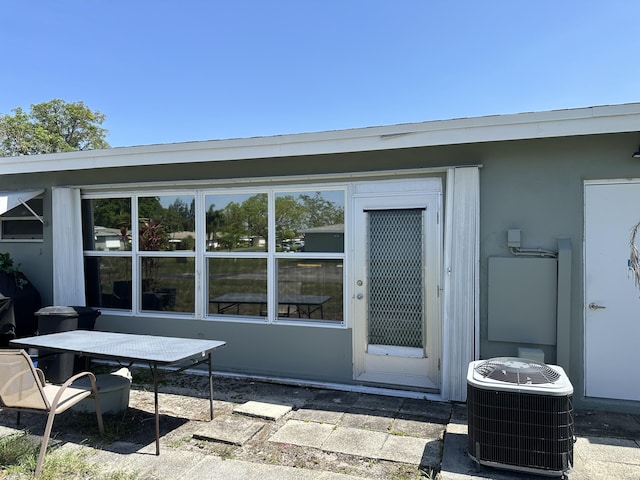 767 E High Point Dr E Unit C, Delray Beach, FL 33445 - doorway to property with central AC, a patio area, and stucco siding