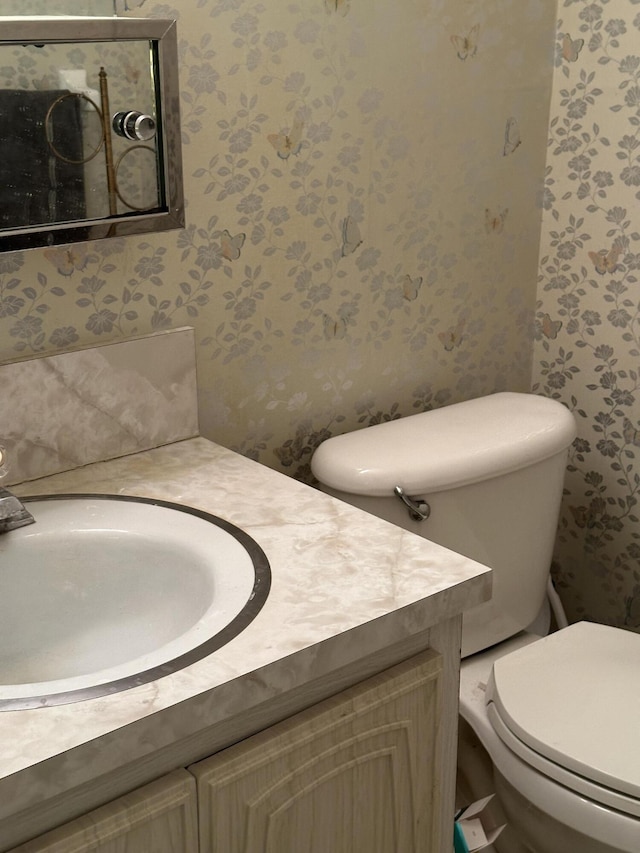 767 E High Point Dr E Unit C, Delray Beach, FL 33445 - half bath with wallpapered walls, vanity, and toilet