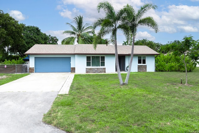 single story home with a garage and a front yard